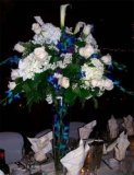 Tall centerpiece in crystal vase with flowers