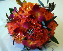 Wedding bouquet with red, brown and maroon flowers