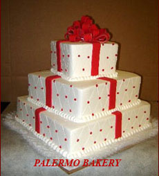 Christmas cake shaped like presents with red ribbon