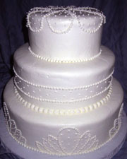 White wedding cake with a simple pearlized decoration