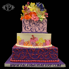 Many colored wedding cake consisting of purple, pink, yellow blue and orange.Unusually colored and designed wedding cakes
