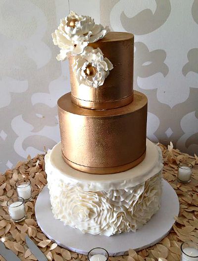 Elegant Wedding Cake with gold petals on the cake table.