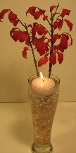 Stunning centerpieces of a floating candle with twigs and leaves