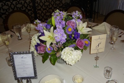 Photo of  a table with the menu along with the centerpiece and table number