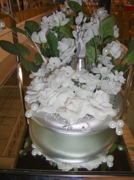 Photo of a Winter Wedding Centerpiece with a bridal couple in the center of the white flowers