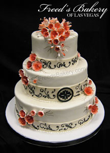 Beautiful fall wedding cake with orange flowers and black scrolling