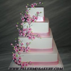 Unusual wedding cakes with pink, pearlized bands and cherry blossoms and branches
