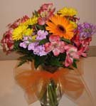 Autumn colored flowers with tulle for a fall centerpiece