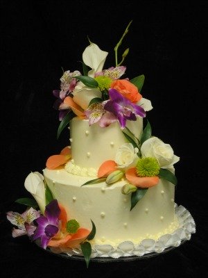 Beautiful tropical theme cake with orchards, roses, calla lilies and mums