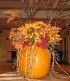 Carved out pumpkin centerpieces with sunflowers