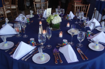 Reception table picture includes M & M favors in a glass jar and a lollypop.